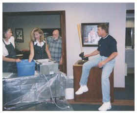 John Elaway and Raelee Frazier taking life cast molds from John's Hands